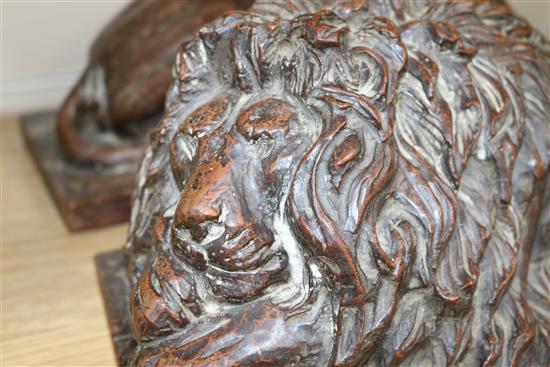 A pair of oak carvings of lions height 15cm width 37cm